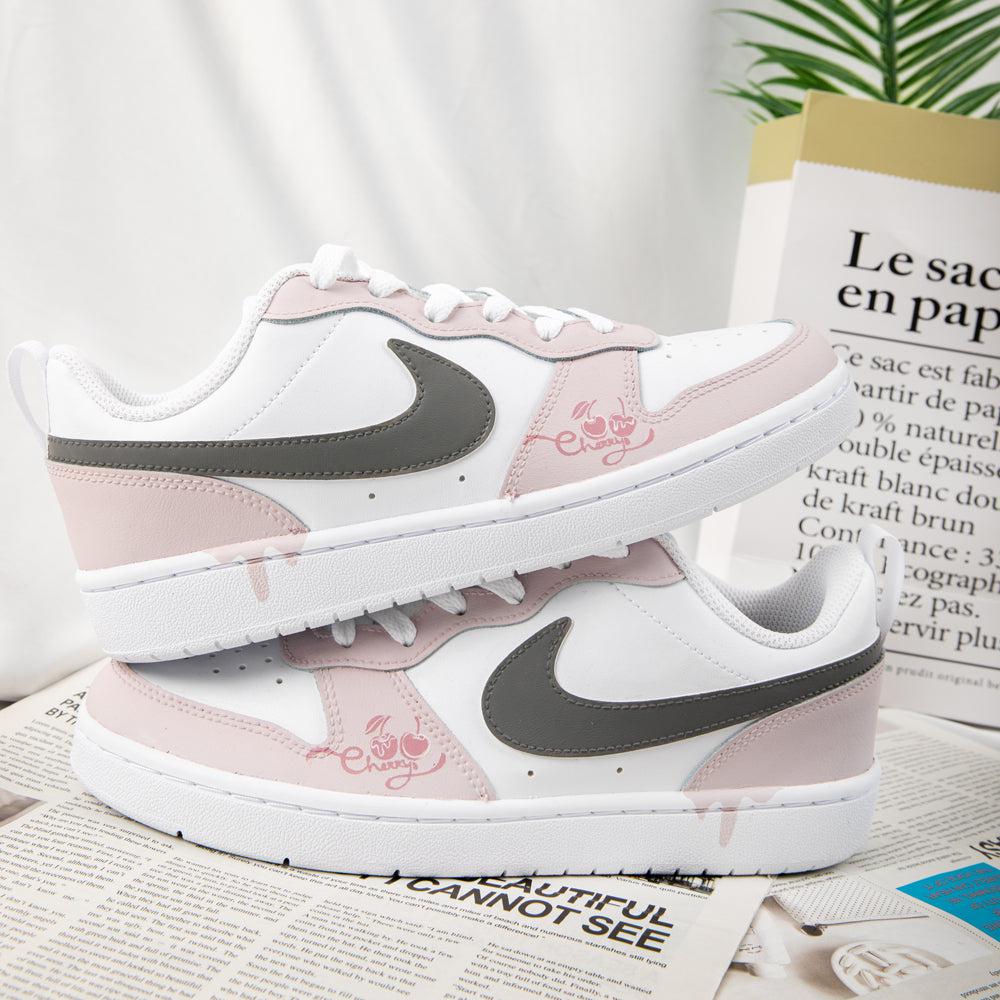 Pink nike shoes store with writing on them