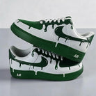 Green and white sneakers with a dripping design on a gray background
